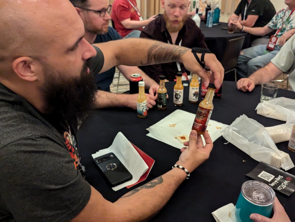 A group tasting hot sauces around a table