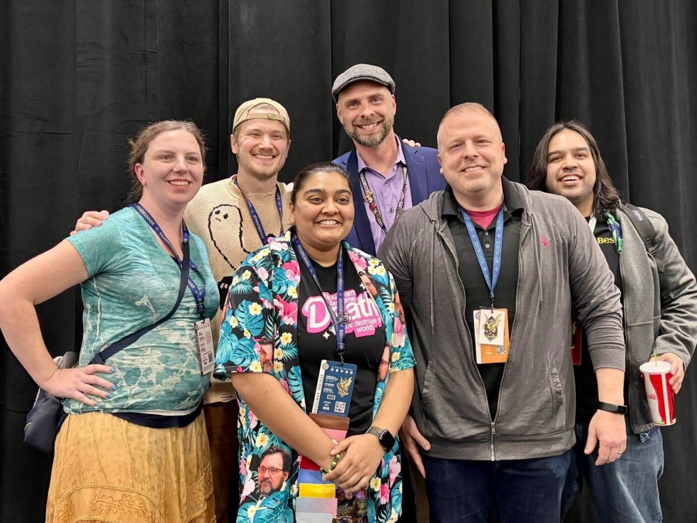 panelists smiling and posing with arms around each other for a photo, with Jacky, Daniel, Jason, and Anas in the back row and Krishna and Matt front and center