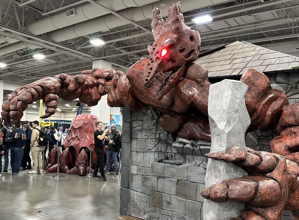 huge sculpture of a thunderclast juts out from a building in the main convention hall